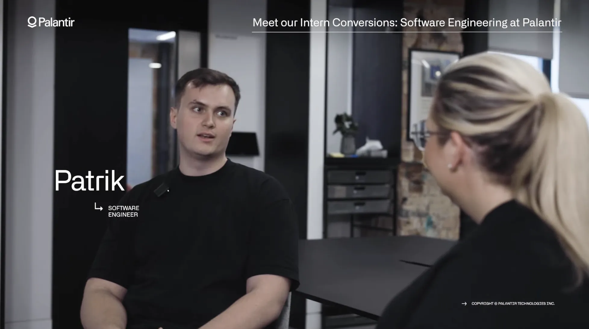 Palantir recruiting video still captioned ‘Patrik, Software Engineer,’ talking with a colleague in the ‘Intern Conversions’ series