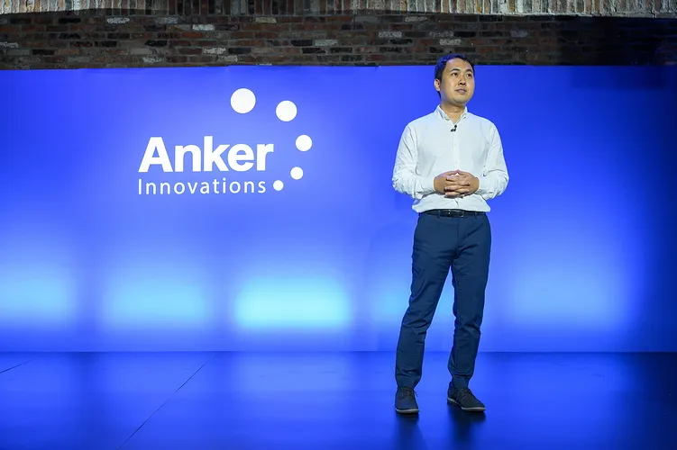 Speaker on stage in front of an Anker Innovations backdrop